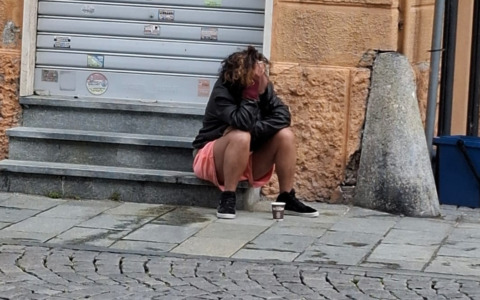 Si sdraia tra le auto (anche nuda) e fa i bisogni davanti ai negozi